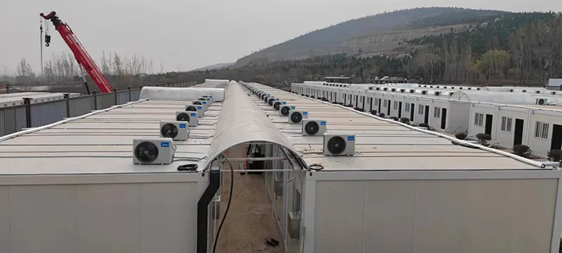 Large modular workforce accommodation camp with rows of prefabricated dormitory units