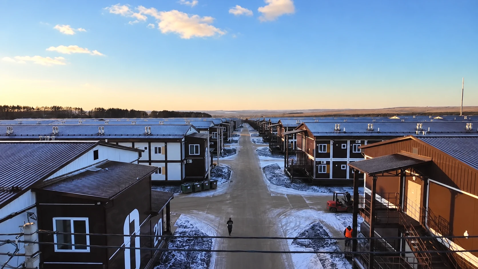 Cold-climate modular workforce camp site in Russia with snow between accommodation buildings