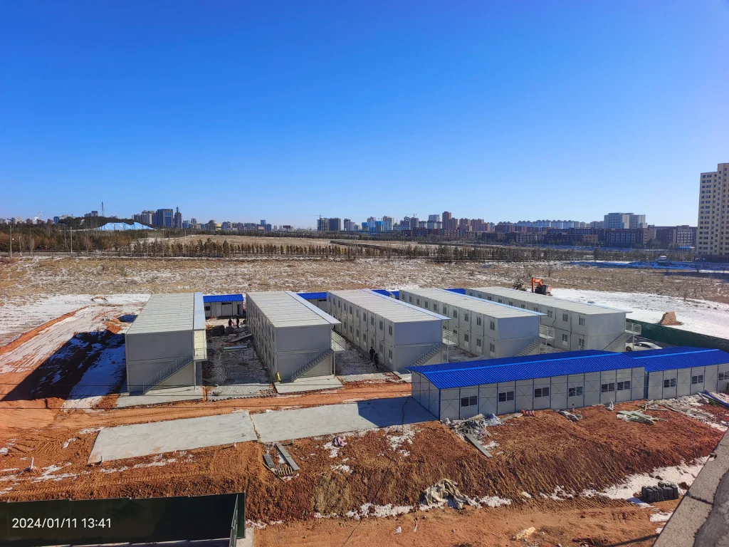 Folding rapid worker dormitory units being deployed at a remote project site