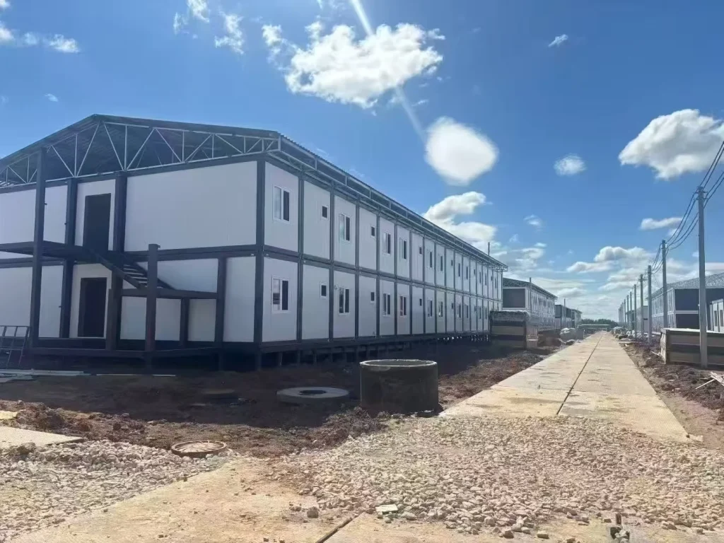 Two-storey modular workforce camp buildings arranged along an internal access road