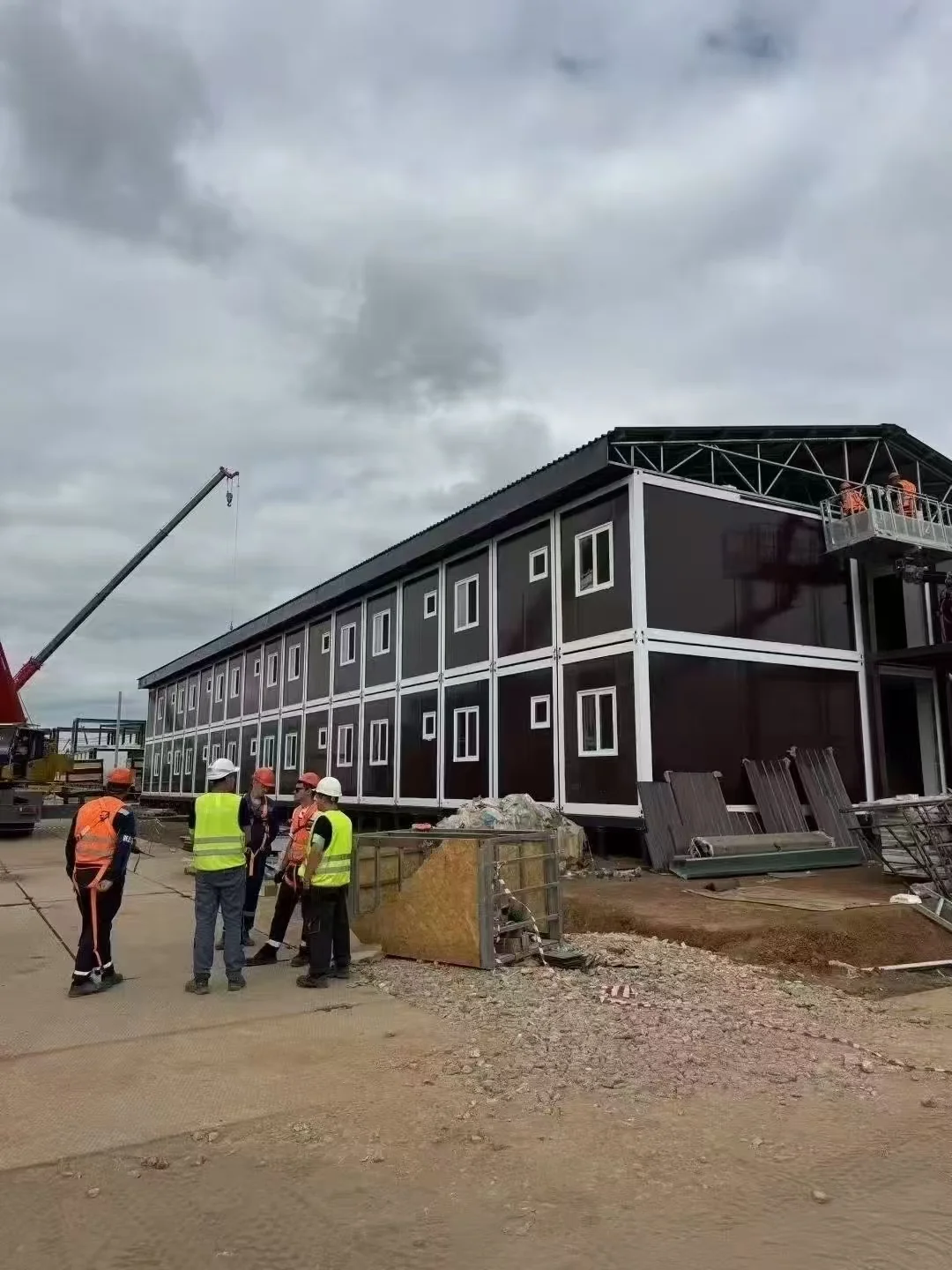 Site crew assembling a multi-storey modular workforce accommodation block