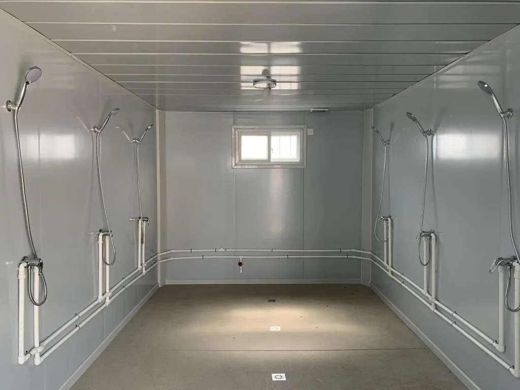 Shower room inside a prefabricated sanitary facility for a construction camp