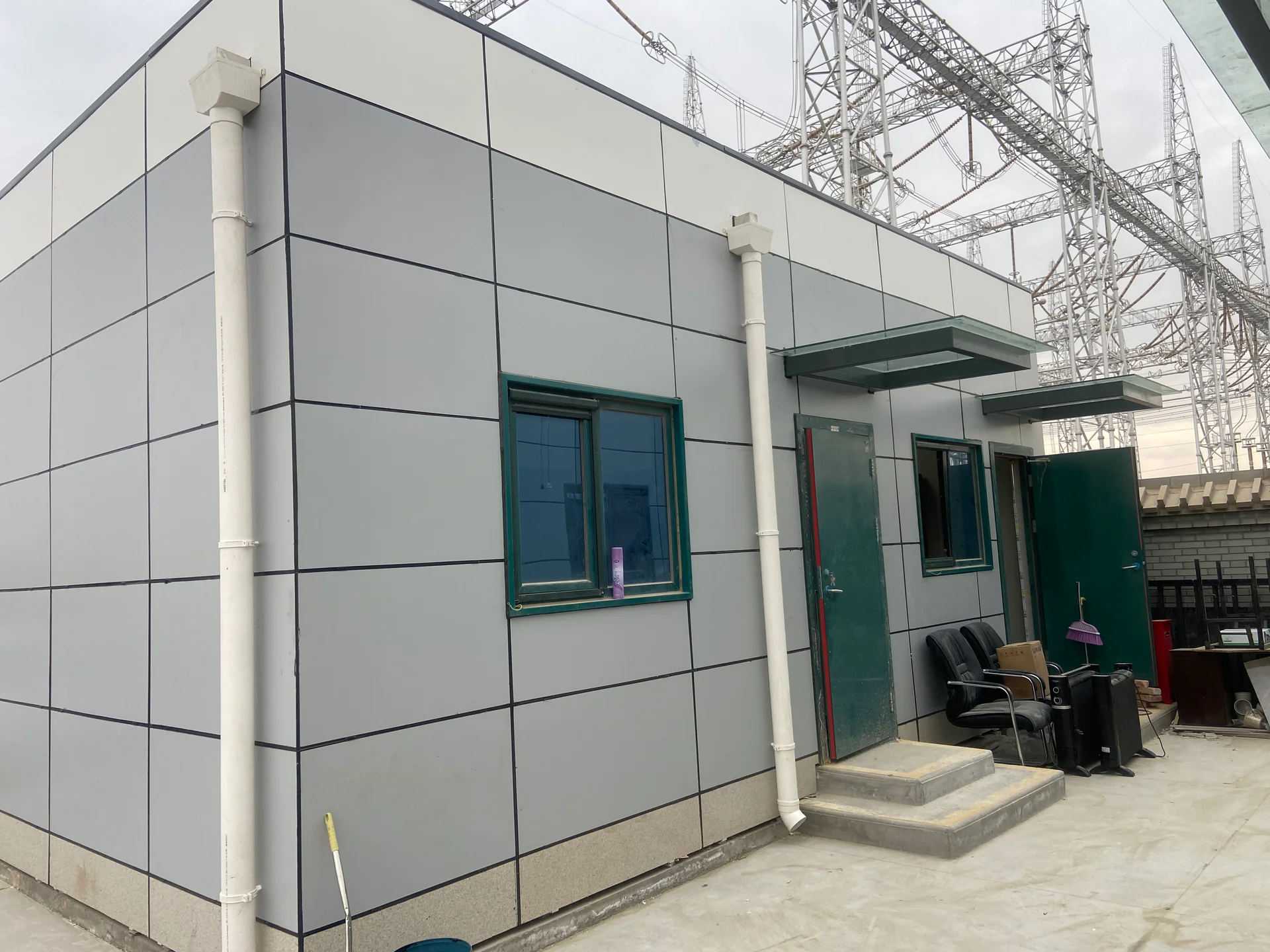 Modular substation support building beside electrical infrastructure