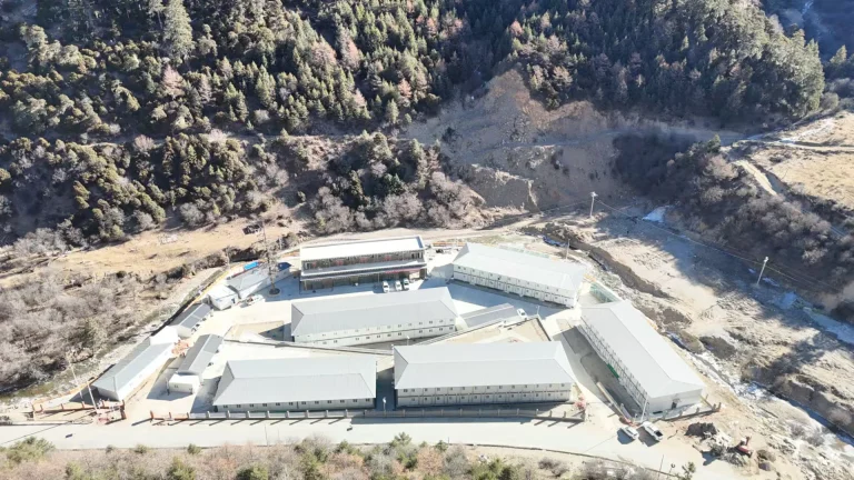 Aerial view of modular workforce camp buildings in remote mountain terrain