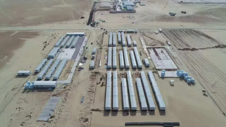 Aerial view of modular workforce camp buildings arranged across a remote arid project site