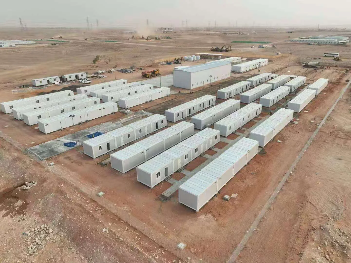 Aerial view of modular accommodation blocks and support buildings in a remote workforce camp