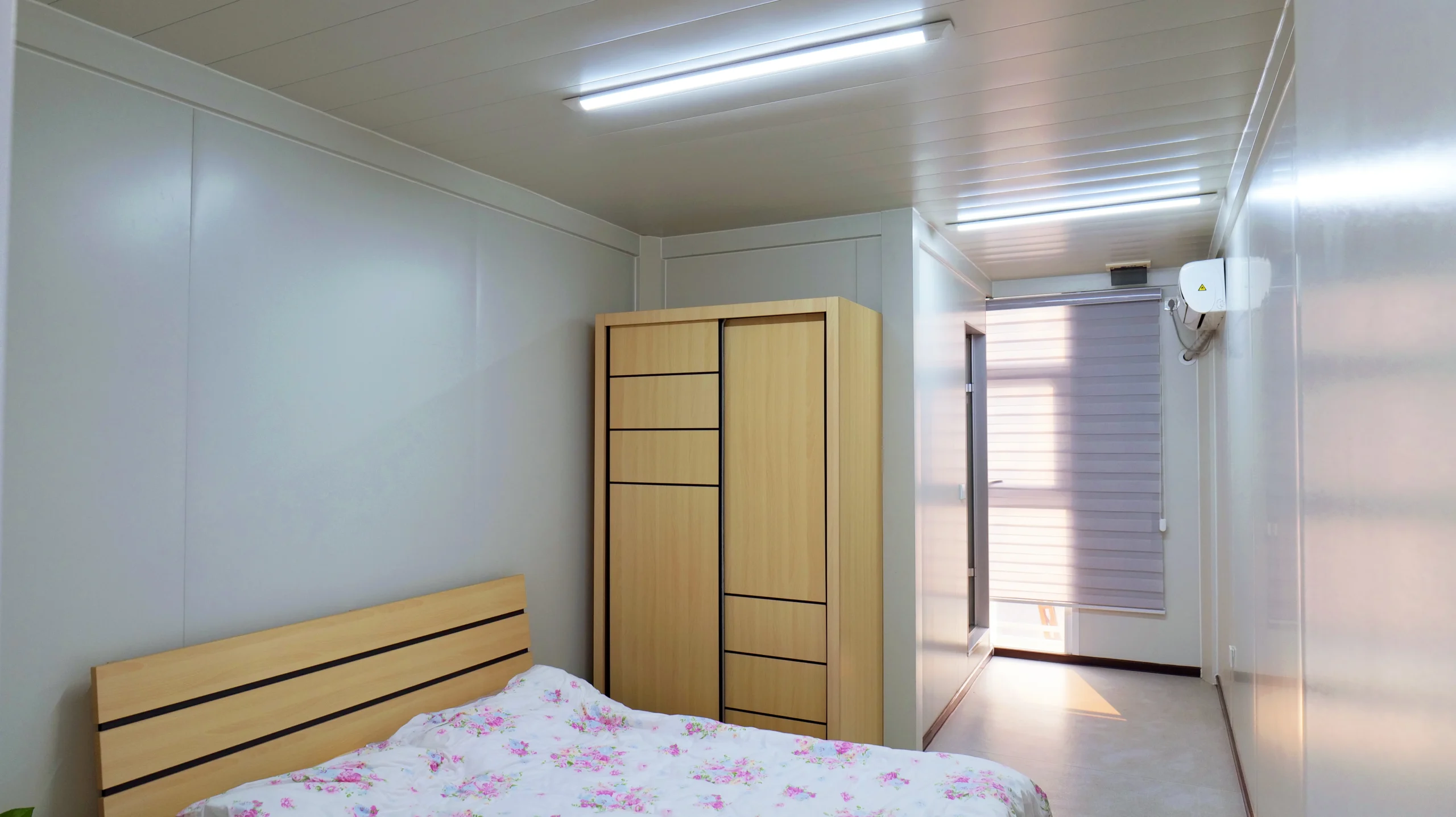 Modular project camp single room with bed, storage wardrobe and air conditioning