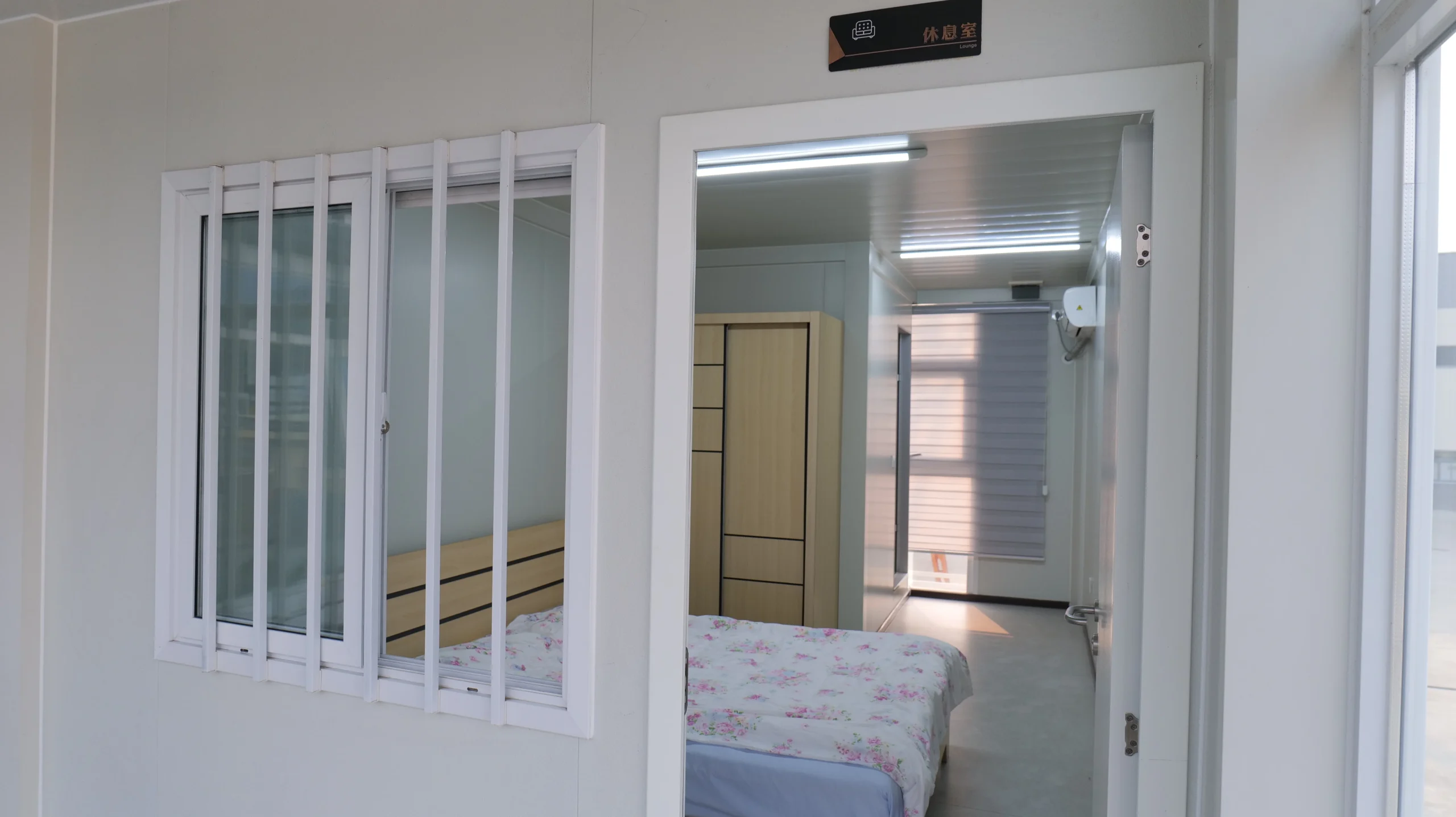 Completed modular worker bedroom with bed, wardrobe, lighting and air conditioning