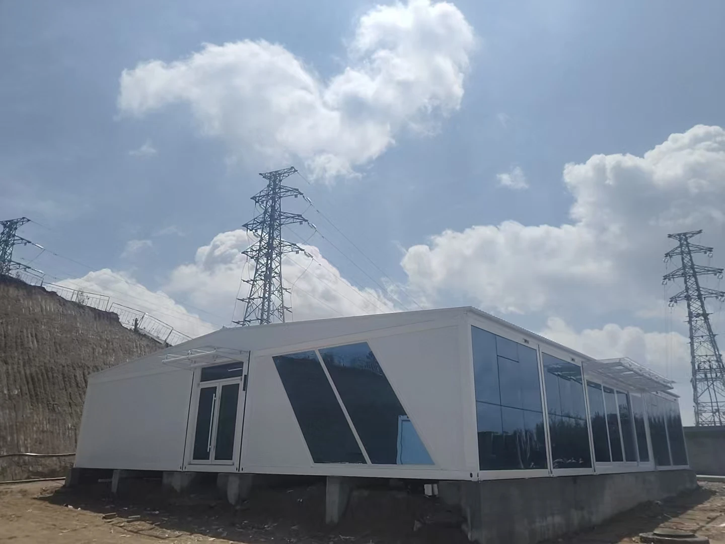 Modular project office installed beside high-voltage grid infrastructure