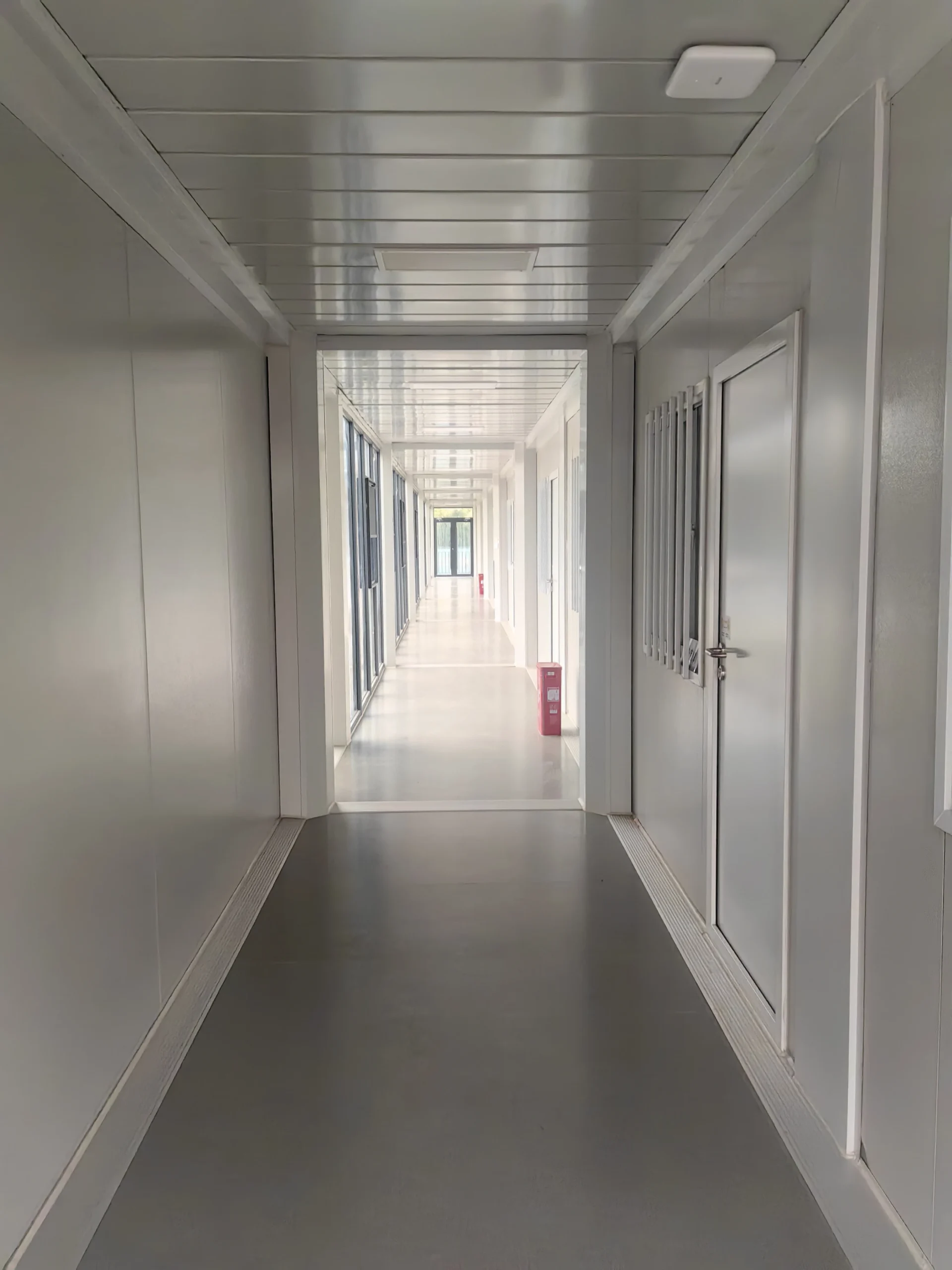 Completed interior corridor in a modular camp building before handover