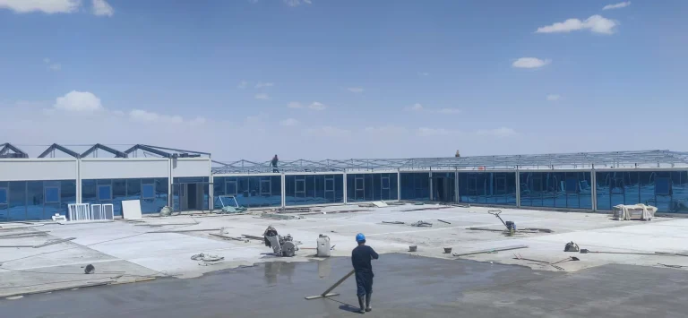 Rows of modular workforce buildings under construction on a remote site