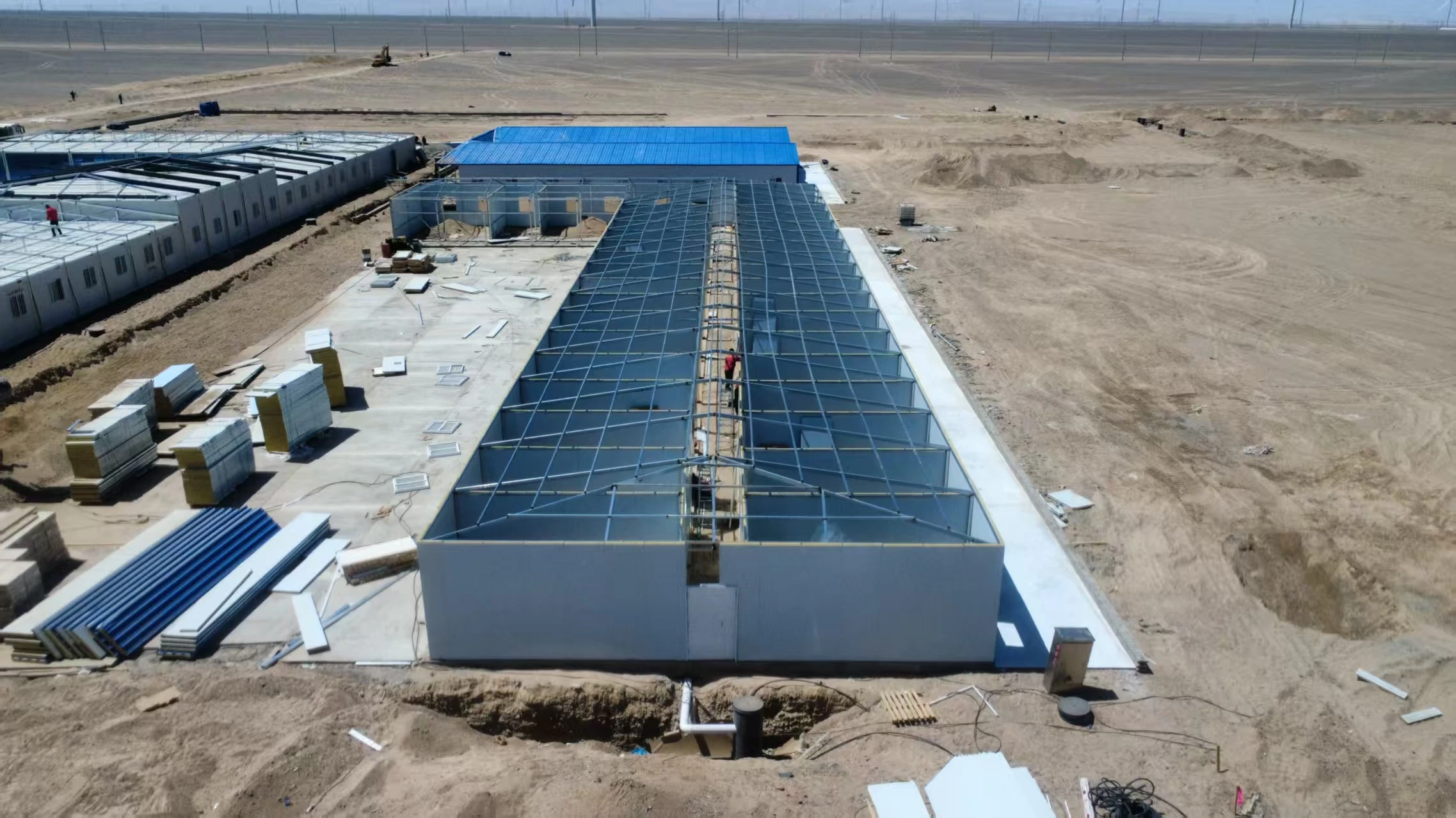 Aerial view of modular camp buildings progressing through on-site construction