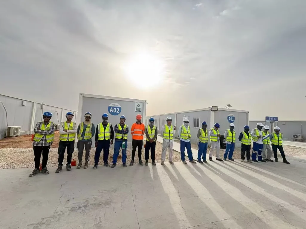 Construction team inside a modular building factory during prefabrication