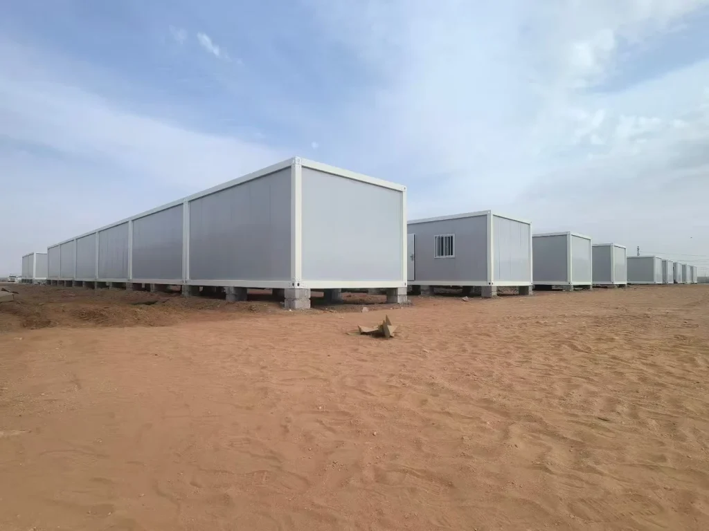 Rows of modular project buildings installed across a remote dry site