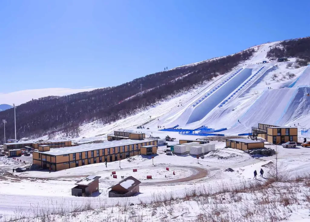 Modular resort accommodation buildings beside a high-altitude ski slope