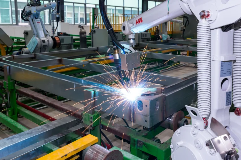 Robotic welding of a KUBO modular steel frame with perimeter members and crossmembers visible