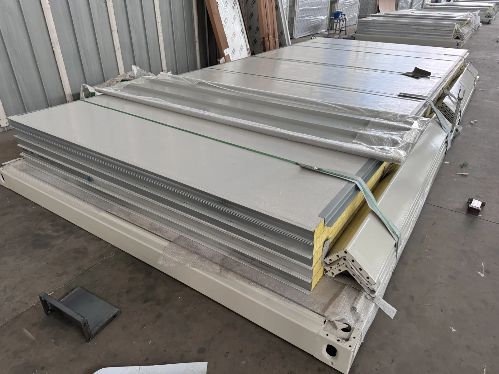 KUBO flat pack component bundle protected and secured with straps in the factory